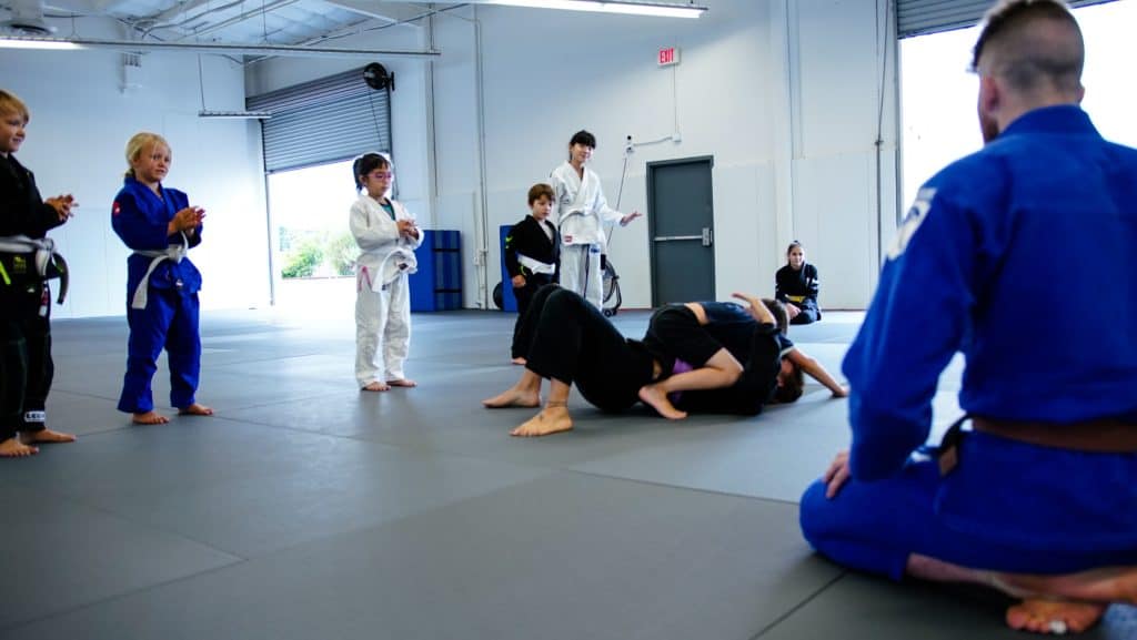 student-demonstrating-mount-control-at-jiu-jitsu-class