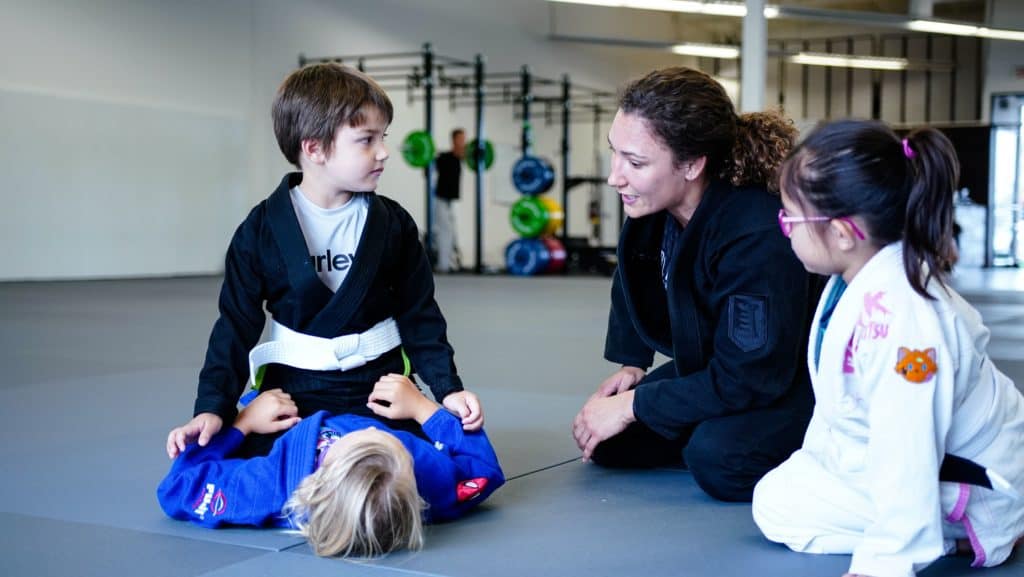 Paige-coaching-kids-through-jiu-jitsu-mount-drill