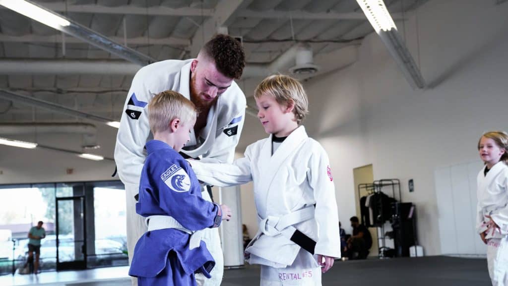 guiding-student-through-technique-in-jiu-jitsu-kids-class